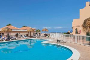 a swimming pool with a view of the ocean at Paradise Court 1 BR Condo with Pool, Costa Adeje in Adeje
