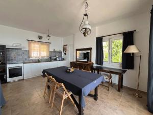 a dining room with a table and a piano at Casa Faustina in Ilia