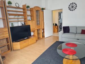 a living room with a couch and a television at Apartment BOZ Solingen 100m2 in Solingen