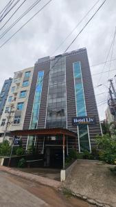 een groot gebouw met een bord aan de voorkant bij Hotel Liv By Yellow Bells in Hyderabad