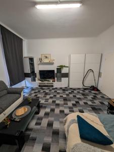 a living room with a couch and a table at Cozy Apartment in Simmering in Vienna +1 photo