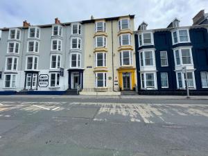 a row of buildings on a city street with a road at Cranwell Court in Aberystwyth