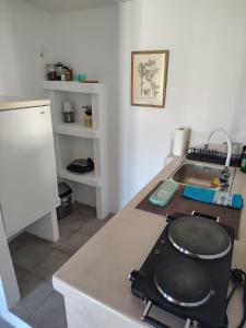 a kitchen with a sink and a stove top oven at Thymariá - Chora view house in Chora Folegandros