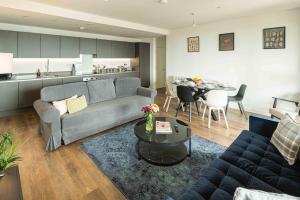 a living room with a couch and a table at Bermondsey Apartments By Sleepy Lodge in London