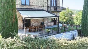 a pavilion with a table and chairs in a garden at Villa Cereja in Piobesi dʼAlba