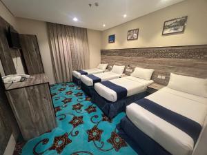 a group of four beds in a room at فندق ليمة الذهبي in Mecca +43 photos