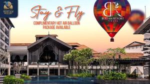 a advertisement for a hotel with a hot air balloon at Bertam Resort & Water Park Penang in Kepala Batas