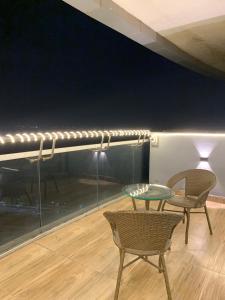 a table and chairs in a room with a stage at The Lux Supernova in New Delhi