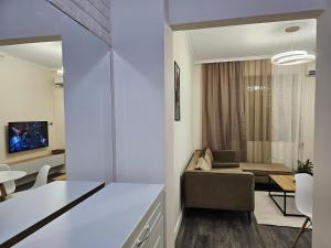 a living room with a couch and a table at DION Apartment in Elbasan