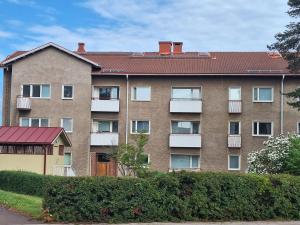 a large brick apartment building with a balcony at Mysiga 21 an in Mariehamn