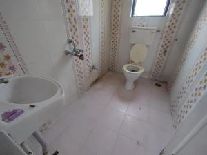 a small bathroom with a toilet and a sink at Professional and Sweet Home in Pune