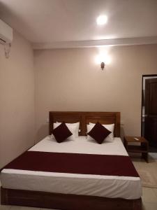 a bedroom with a large bed with two pillows at The Trees Dambulla in Dambulla