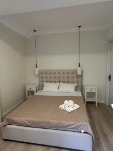 a bedroom with a bed with two towels on it at Nitsa Downtown Apartment in Kutaisi