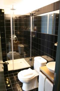 a bathroom with a toilet and a shower and a sink at 2U Oporto Urban Stays in Porto