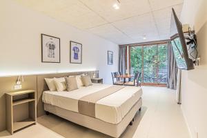 a bedroom with a large bed and a table at Deluxe Recoleta Apartments - By Magno in Buenos Aires