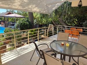 a patio with a table and chairs and a pool at Villa Filip Coral Bay in Peyia