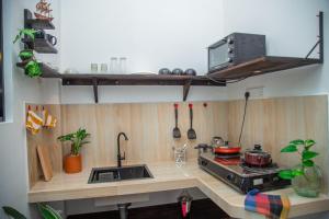a kitchen with a stove and a counter top at Vibe green villa in Unawatuna +9 photos