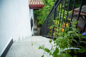 a stairway leading up to a house with a fence at Vibe green villa in Unawatuna