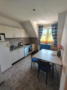 a kitchen with a table and chairs and a refrigerator at D.A.R. - Slovenský Raj in Letanovce