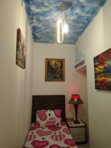 a bedroom with a bed with a painted ceiling at Frank spaces in Abu Dhabi
