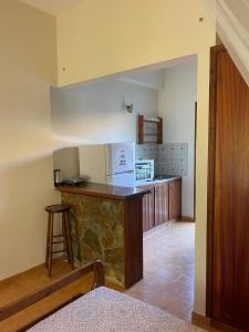 a kitchen with a counter and a stove top oven at Castello Bellos studios in Marathias