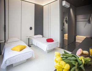 a room with two beds and a table with food at Sunday Hotel in Odesa