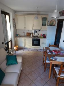 a living room with a white couch and a table at Teddy House in Porcari +39 photos