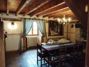 a dining room with a table and chairs in a room at Les Faes du Bos in Saint-Beauzire +25 photos