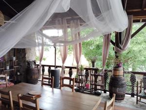 a dining room with a wooden table and chairs at Les Faes du Bos in Saint-Beauzire