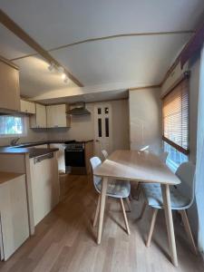 a kitchen and dining room with a table and chairs at Camping Moraira in Moraira +16 photos