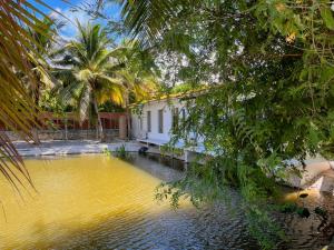 a pool of water in front of a house at Phimai Pond House in Pi Mai