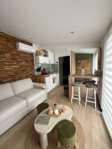 a living room with a couch and a table at Superbe cocon chic, clim et terrasse privée, déco soignée in Nevers