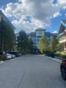 a large building with a clock tower on top of it at Pine Suites Tagaytay by Crown Asia in Tagaytay