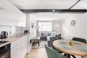 a kitchen and living room with a table and chairs at The Barack Nest Colchester in Colchester