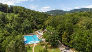 an overhead view of a swimming pool in a forest at Hotel Toplice - Terme Krka in Smarjeske Toplice +74 photos
