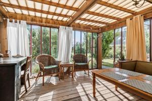 a living room with a table and chairs and windows at R608-Rodvig-Klintevej-32 in Rødvig