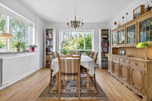 a dining room with a table and a chandelier at R608-Rodvig-Klintevej-32 in Rødvig