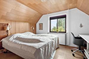 a bedroom with a bed and a desk and a window at R608-Rodvig-Klintevej-32 in Rødvig