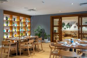 a dining room with wooden tables and chairs at Aztec Hotel and Spa in Bristol +30 photos