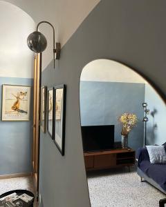 a living room with a mirror and a tv at Locazione Culturale - Short Rent in Atri - in Atri