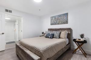 a bedroom with a large bed in a white room at UF Apartment on Archer Road Near Shands & VA ! in Gainesville
