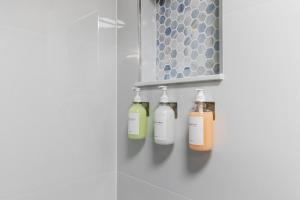 a bathroom with four bottles on a shelf at UF Apartment on Archer Road Near Shands & VA ! in Gainesville +23 photos