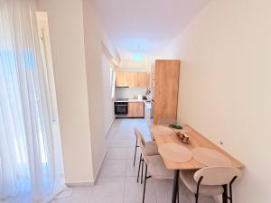 une cuisine et une salle à manger avec une table et des chaises en bois dans l'établissement Kraja Home, à Shkodër