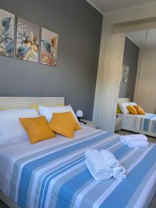 a bedroom with a large bed with towels on it at Damar in Giarre