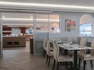 a dining room with a table and chairs at Atlantica SunGarden Beach in Ayia Napa