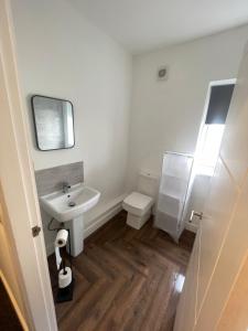 a white bathroom with a sink and a toilet at 275 Queen Street-Flat 2 in Withernsea
