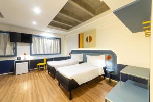 a hospital room with two beds and a desk at ibis Styles Fortaleza Shopping Giga Mall in Fortaleza +71 photos