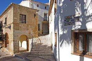 an alley with a sign on the side of a building at Camping Moraira in Moraira