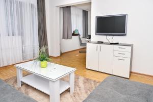 a living room with a tv and a table at Apartman Nina in Jajce