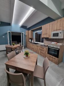 a kitchen with a wooden table and chairs in a room at Borgo Barone in Calimera